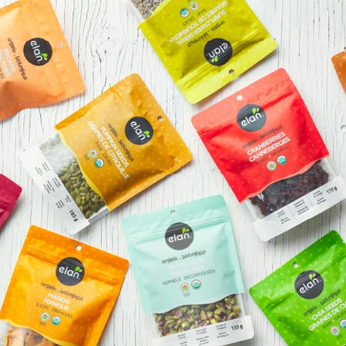Assorted packages of elan organic seeds and snacks on a white surface