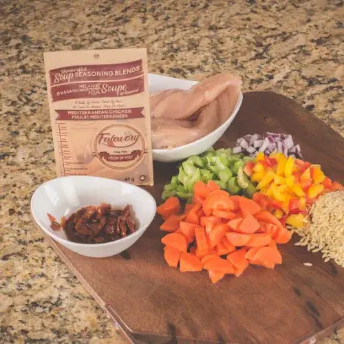 Wooden cutting board with ingredients and Falavory seasoning blend on a countertop