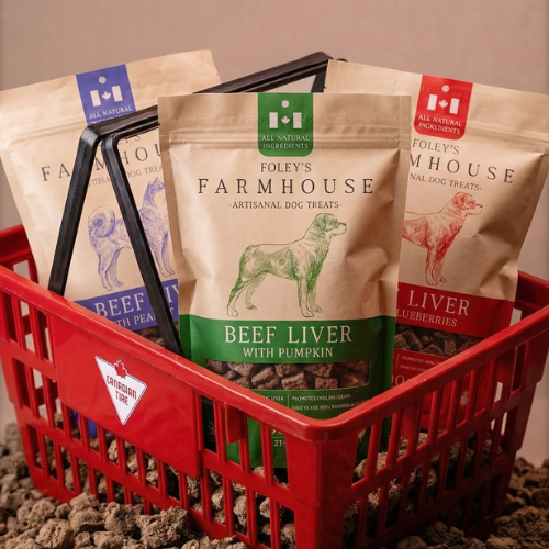 Foley Farmhouse dog treat packages in a red basket with a neutral background