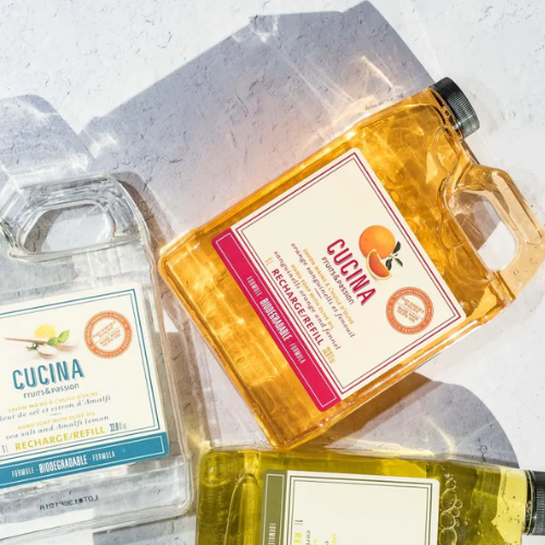 Three bottles of Cucina products on a textured surface