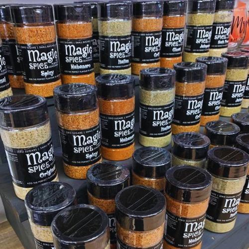 Multiple jars of  Hayley's Magic Spice seasoning on a table