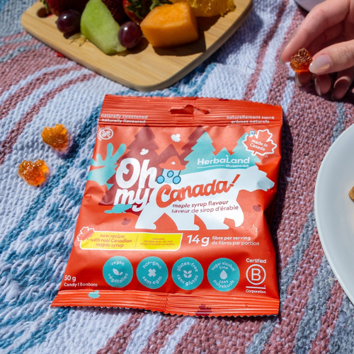 Herbaland Oh My Canada maple syrup flavoured gummy candy bag on a picnic blanket