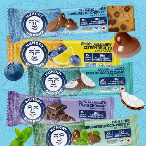 Collection of Hungry Buddha protein bars with various flavors on a blue background