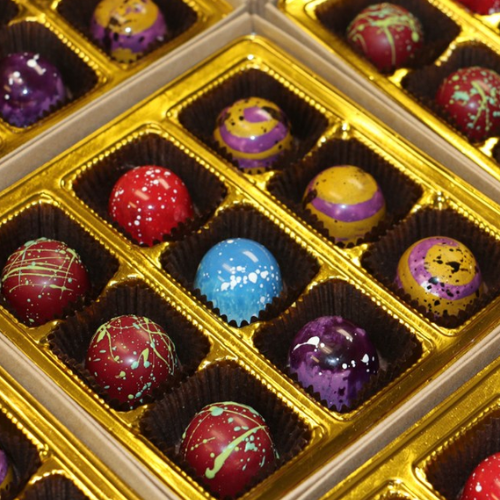 Assorted colourful chocolates in a gold box