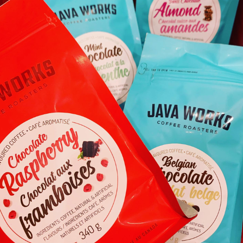 Java Works coffee packages with various flavors on a wooden surface