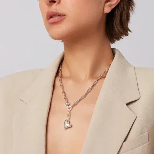Woman wearing a chunky silver heart pendant necklace from Canadian-owned jewellery brand Jenny Bird