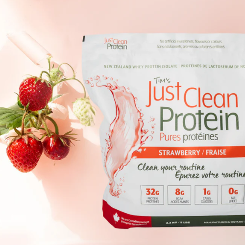 Just Clean Protein package with strawberries on a light pink background