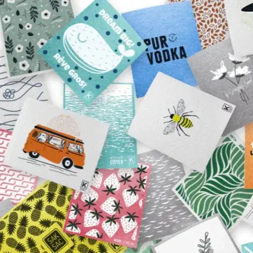 Collection of variously designed cleaning towels with different patterns and text.