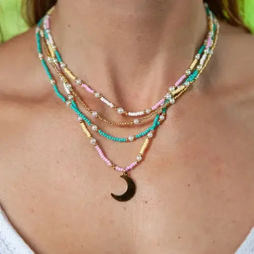 Handmade beaded necklaces with crescent moon pendant by Canadian-owned jewellery brand Manguaré