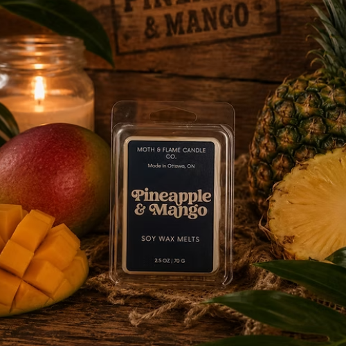 Pineapple and mango wax melts packaging with a pineapple, mango, and candle in the background.