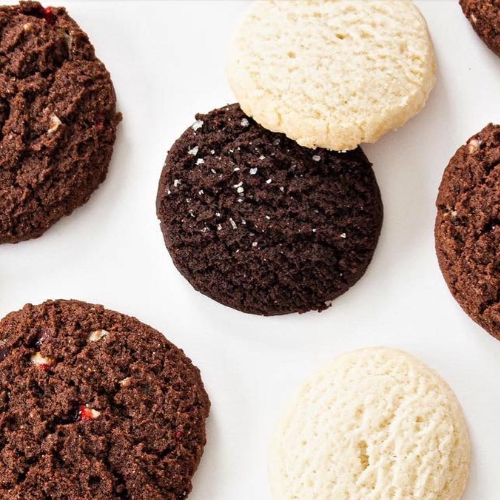 Assorted cookies including chocolate and vanilla on a white surface