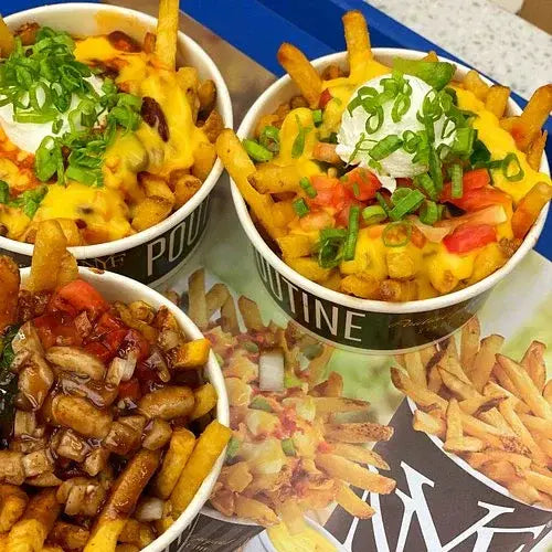 Three bowls of loaded New York Fries fries with various toppings on a magazine cover.