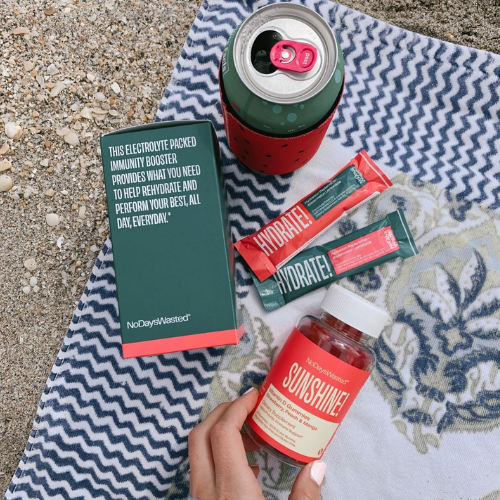 Collection of No Days Wasted products including a can, packets, and a bottle on a textured surface.
