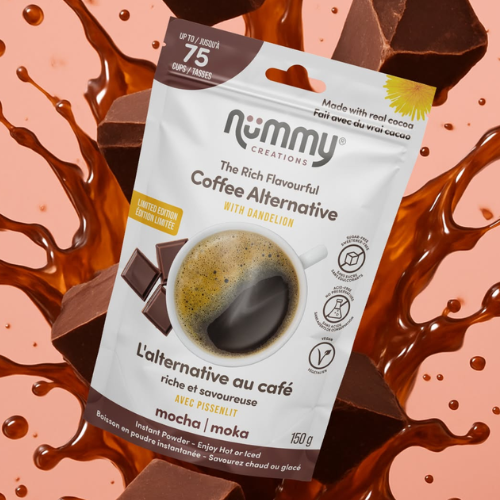 A stand-up pouch of Nummy Creations 'The Rich Flavourful Coffee Alternative' with Ganelon, mocha flavour, surrounded by chocolate splashes and chunks on a peach background.