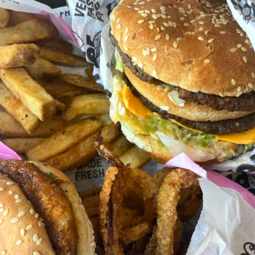 Burger with fries and onion rings on a paper tray