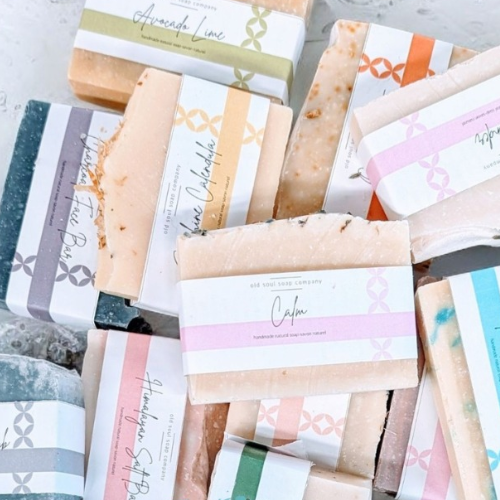 Collection of variously wrapped soap bars with different designs and text.