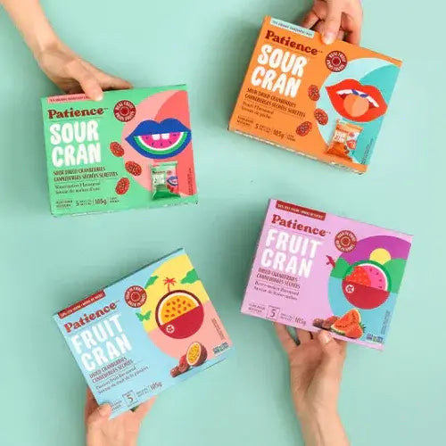 Four boxes of Patience Fruit Gran on a light blue background