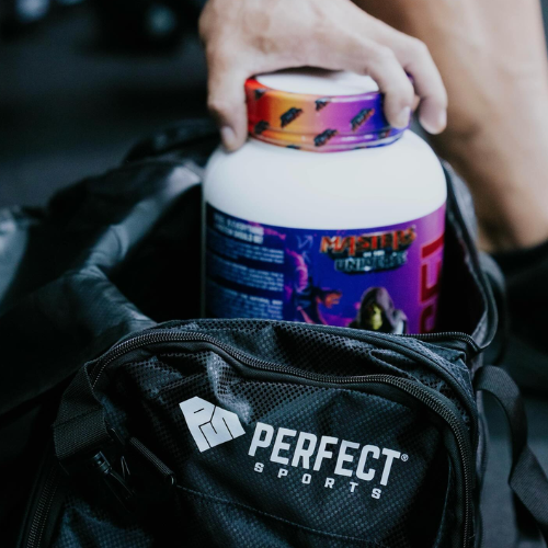 Person holding a supplement bottle with a colourful label over a Perfect Sports bag.