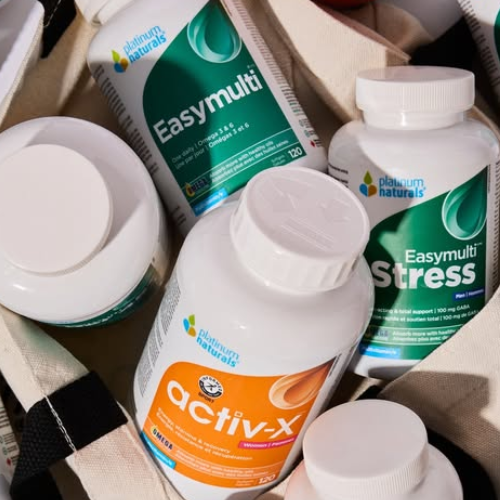 Collection of health and wellness products including 'Easymulti', 'Stress', and 'activ-X' bottles on a textured surface.