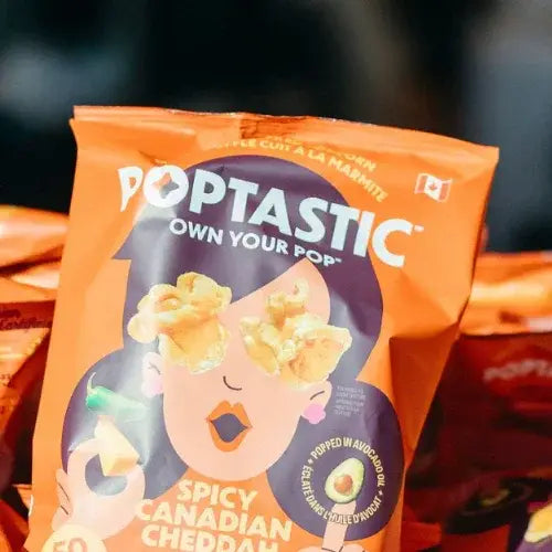 Poptastic popcorn bag with a stylized illustration of a person eating popcorn on an orange background.