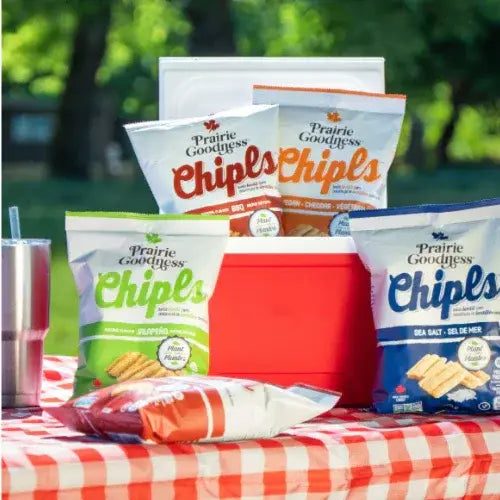 Prairie Goodness Chips! bags on a picnic table with a red cooler in the background.
