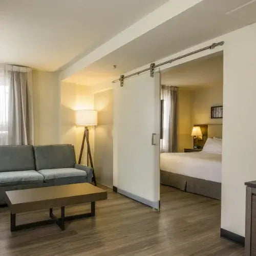 Modern hotel room with living area and bedroom