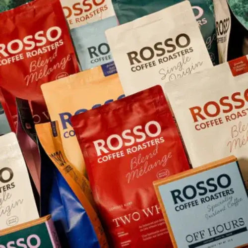 Collection of Rosso Coffee Roasters coffee packages in various colors.