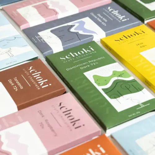 Collection of Schoki chocolate bars with colourful packaging on a white background