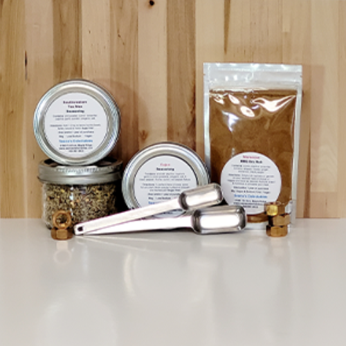 Spices and seasonings with labelled containers and packaging on a wooden surface