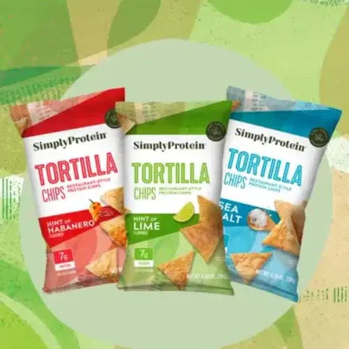 Three packages of Simply Protein Tortilla Chips on a green background