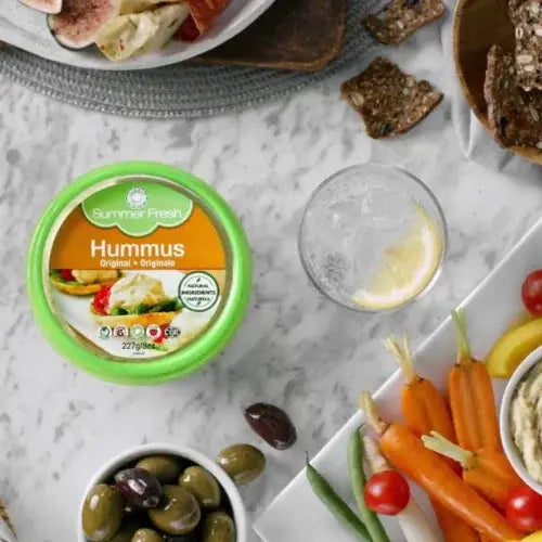 Summer Fresh Hummus container on a table with vegetables and bread
