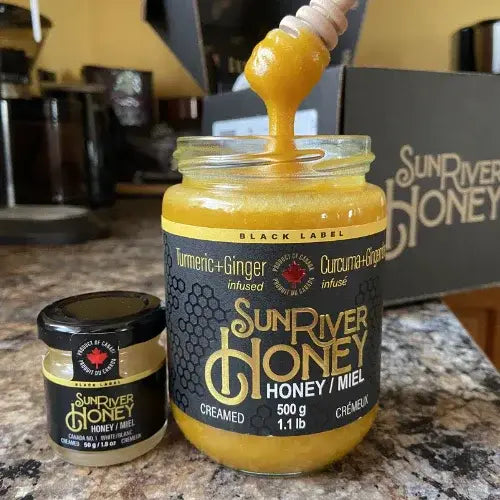 SunRiver Honey jar with honey being drizzled over it on a kitchen counter.