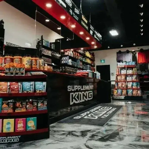 Interior of Supplement King store with shelves of protein powders, snacks, and fitness gear – Canadian-owned supplement retailer