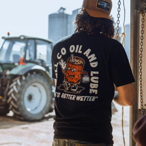 Man wearing black t-shirt with writing on it that says troll co oil and lube