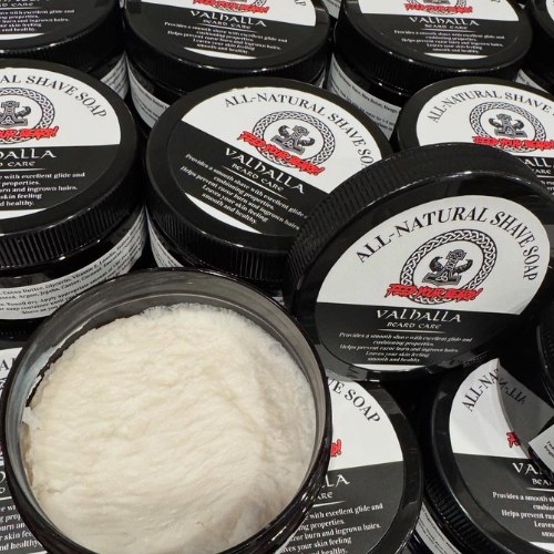 Collection of Valhalla all-natural shave soaps with one open showing white soap.