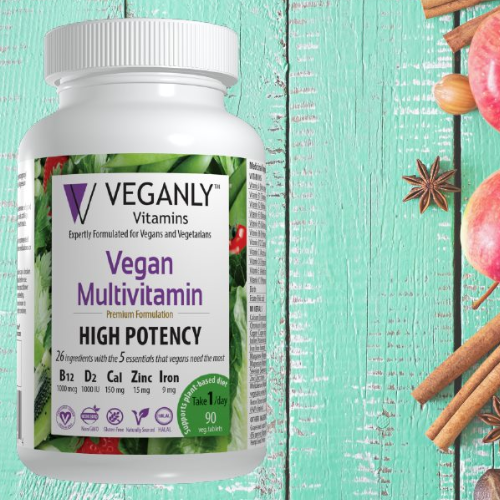 Vegan multivitamin bottle with ingredients on a teal wooden background