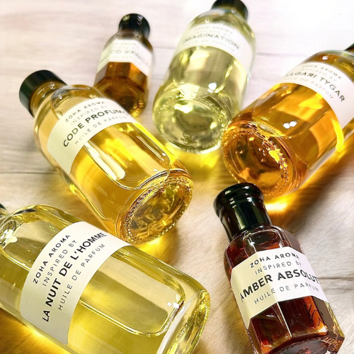 Collection of small bottles with labels on a light wooden surface